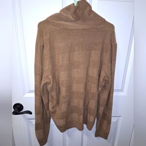A Geoffrey Beene long sleeve turtleneck sweater in a size large.